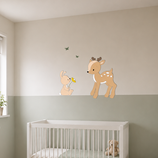 Babykamer met wit ledikant, groene lambrisering en houten wanddecoratie van een hertje en konijntje met vlinders.